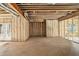 Unfinished basement featuring insulated walls, exposed beams, framed walls, and a concrete floor at 7519 Waterview Cv, Douglasville, GA 30135