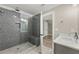 Bathroom showcasing a tiled walk-in shower and sink with neutral tones throughout the space at 7519 Waterview Cv, Douglasville, GA 30135
