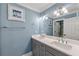 Stylish bathroom showcasing double sinks, a large mirror, and soft blue wall paint at 7519 Waterview Cv, Douglasville, GA 30135