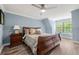 Comfortable bedroom features a plush bed, a nightstand, and a window providing natural light at 7519 Waterview Cv, Douglasville, GA 30135