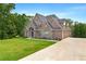 Two-story brick home with a three-car garage and manicured front yard at 7519 Waterview Cv, Douglasville, GA 30135
