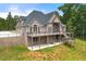 Impressive brick home with a large deck, multiple windows, and a well-maintained lawn at 7519 Waterview Cv, Douglasville, GA 30135
