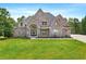 Beautiful two-story brick home with manicured lawn and arched entryway at 7519 Waterview Cv, Douglasville, GA 30135