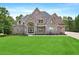 Beautiful two-story brick home with manicured lawn and arched entryway at 7519 Waterview Cv, Douglasville, GA 30135