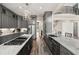 Spacious kitchen showcasing gray cabinetry, stainless steel appliances, and a marble countertop island at 7519 Waterview Cv, Douglasville, GA 30135