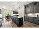 Bright kitchen with gray cabinets, marble countertops, and an adjacent dining area with natural light at 7519 Waterview Cv, Douglasville, GA 30135