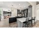 Modern kitchen boasts gray cabinets, a marble island, and a view into the living area at 7519 Waterview Cv, Douglasville, GA 30135
