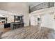 Open-concept living room featuring hardwood floors, a kitchen, and a wrought iron balcony at 7519 Waterview Cv, Douglasville, GA 30135
