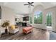 Bright living room with custom bar, arched window, and access to dining and outdoor areas at 7519 Waterview Cv, Douglasville, GA 30135