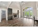 Open living room with stone fireplace, built-ins, and French doors to the deck at 7519 Waterview Cv, Douglasville, GA 30135