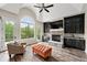 Bright living room features an arched window, stone fireplace, and vaulted ceilings for natural light at 7519 Waterview Cv, Douglasville, GA 30135