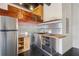 A modern kitchen featuring stainless steel appliances, stainless steel backsplash and butcher block countertops at 878 Ne Peachtree Ne St # 326, Atlanta, GA 30309