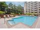 Community pool with lounge chairs and umbrellas in an urban setting at 878 Ne Peachtree Ne St # 326, Atlanta, GA 30309