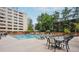 Community pool with lounge chairs, tables and lush landscaping in an urban setting at 878 Ne Peachtree Ne St # 326, Atlanta, GA 30309