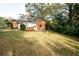 Landscaped backyard with a well-maintained lawn and mature trees adding shade at 6332 N Hampton N Dr, Atlanta, GA 30328