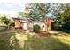Well-maintained lawn in backyard with a brick building and ample landscaping at 6332 N Hampton N Dr, Atlanta, GA 30328
