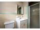 Vintage bathroom with retro-tiled shower and walls, featuring a classic vanity and fixtures at 6332 N Hampton N Dr, Atlanta, GA 30328