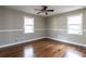 Serene bedroom with hardwood floors and wainscoting, naturally lit by two windows overlooking the backyard at 6332 N Hampton N Dr, Atlanta, GA 30328