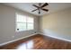 Comfortable bedroom with hardwood floors and a ceiling fan, bathed in natural light from the window at 6332 N Hampton N Dr, Atlanta, GA 30328