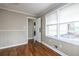 Charming bedroom with hardwood floors, wainscoting, and an open doorway, filled with natural light at 6332 N Hampton N Dr, Atlanta, GA 30328