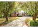 Ranch style home with mature trees and green grass in the front yard at 6332 N Hampton N Dr, Atlanta, GA 30328