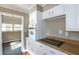 Well-appointed kitchen with white cabinets, wood countertops, and modern appliances, creating an inviting cooking space at 6332 N Hampton N Dr, Atlanta, GA 30328