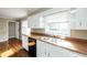 Practical kitchen area with white cabinets, wood countertops, and a stainless steel sink, maximizing functionality at 6332 N Hampton N Dr, Atlanta, GA 30328