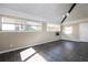 Inviting living room with wainscoting and dark tile flooring, illuminated by natural light from multiple windows at 6332 N Hampton N Dr, Atlanta, GA 30328