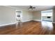 Bright living room featuring hardwood floors, an open layout, and wainscoting, with views to the kitchen at 6332 N Hampton N Dr, Atlanta, GA 30328