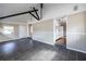 Open-concept living room with dark tile floors and views into the kitchen, complemented by stylish wainscoting at 6332 N Hampton N Dr, Atlanta, GA 30328