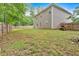 A spacious backyard with a lawn, wooden fence, and a lawn mower at 6350 Summer Pl, Douglasville, GA 30135