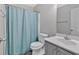 Modern bathroom with framed mirror, blue shower curtain, and white vanity at 6350 Summer Pl, Douglasville, GA 30135