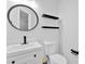 Modern bathroom featuring a round mirror, shelves, toilet and vessel sink at 6350 Summer Pl, Douglasville, GA 30135