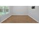 Bright, airy room featuring wood floors, white trim, and a wall-mounted TV bracket at 6350 Summer Pl, Douglasville, GA 30135