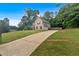 Two-story home with long drive, complemented by lush greenery and a private, fenced backyard at 6350 Summer Pl, Douglasville, GA 30135