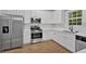 Modern kitchen featuring stainless steel appliances, white cabinets, and quartz countertops at 6350 Summer Pl, Douglasville, GA 30135