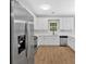 Bright kitchen featuring stainless steel appliances, white cabinets, and white tile backsplash at 6350 Summer Pl, Douglasville, GA 30135