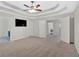 A large main bedroom features a tray ceiling and neutral walls and trim at 6350 Summer Pl, Douglasville, GA 30135