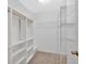 Walk-in closet featuring built in shelves and wood trim at 6350 Summer Pl, Douglasville, GA 30135
