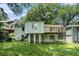 Expansive backyard featuring a wooden deck, lower level patio, and mature shade trees at 1212 Eastridge Sw Rd, Atlanta, GA 30311