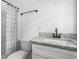 Updated bathroom featuring a granite vanity top and modern black fixtures at 1212 Eastridge Sw Rd, Atlanta, GA 30311
