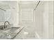 Bright bathroom with granite countertop, white fixtures, and a tub/shower combo at 1212 Eastridge Sw Rd, Atlanta, GA 30311