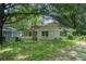 Charming one-story home with a covered front porch and a mature, tree-filled front yard at 1212 Eastridge Sw Rd, Atlanta, GA 30311
