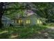 Charming one-story home with a covered front porch and a mature, tree-filled front yard at 1212 Eastridge Sw Rd, Atlanta, GA 30311