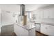 Bright kitchen features white cabinetry, granite countertops, stainless steel appliances and center island at 1212 Eastridge Sw Rd, Atlanta, GA 30311