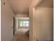 Open-concept entryway leading into a bright living area with large windows, construction underway at 2753 S Waterworks Rd, Buford, GA 30518