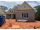 Newly built two-story home with brick facade and a well-lit interior under a cloudy sky at 2753 S Waterworks Rd, Buford, GA 30518