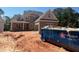 New brick home construction with gray trim, new windows, and a large blue Republic Services dumpster at 2753 S Waterworks Rd, Buford, GA 30518