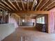 An unfinished interior showcases the home's structure, featuring pink insulation and natural light through large windows at 2753 S Waterworks Rd, Buford, GA 30518