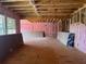 Spacious interior framed with wooden beams and pink insulation, featuring plywood panels and natural light at 2753 S Waterworks Rd, Buford, GA 30518